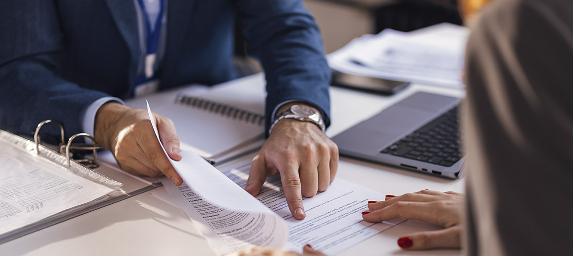 mans hands on work papers