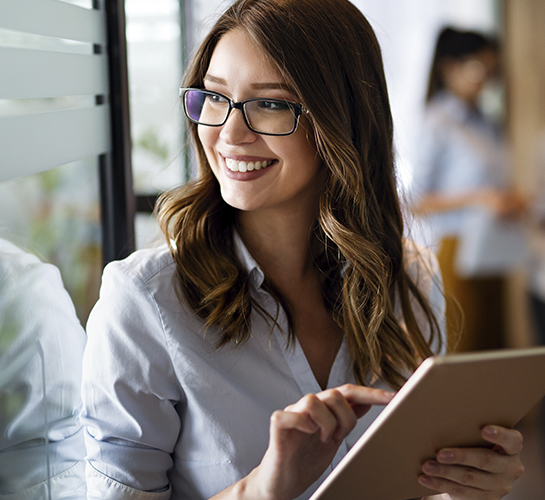women smiling with a tablet