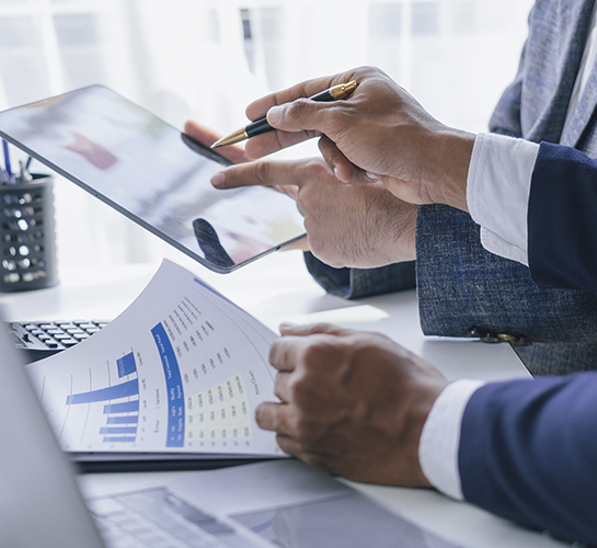 hands pointing pens at a laptop