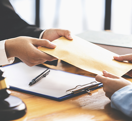 hands holding a manilla enevelope