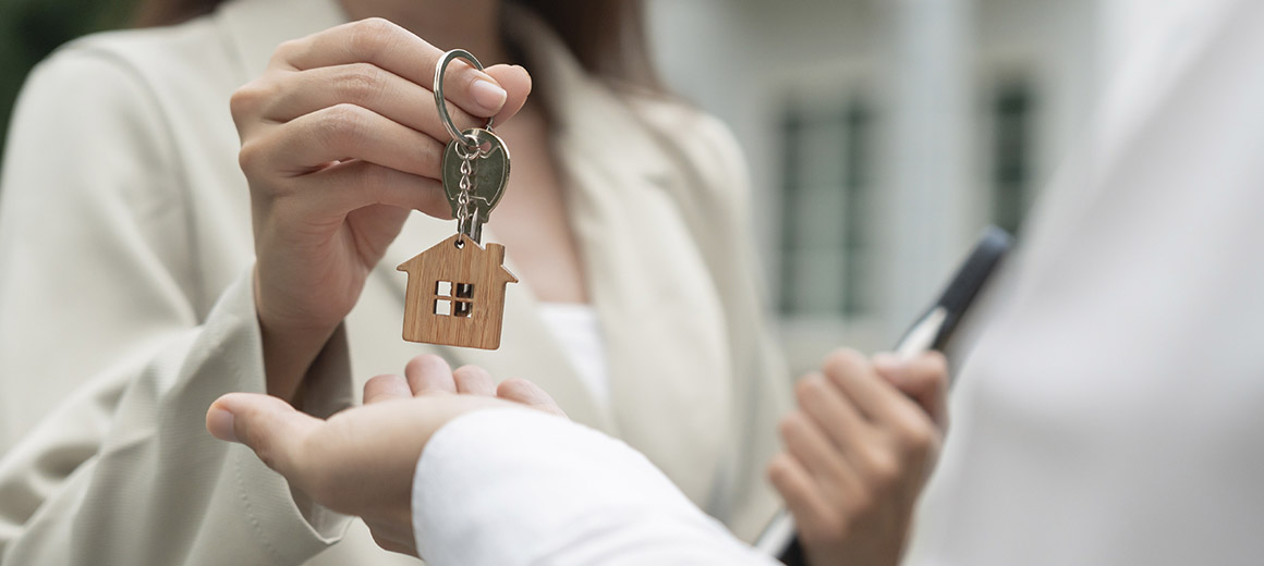 woman placing keys into the hand of someone