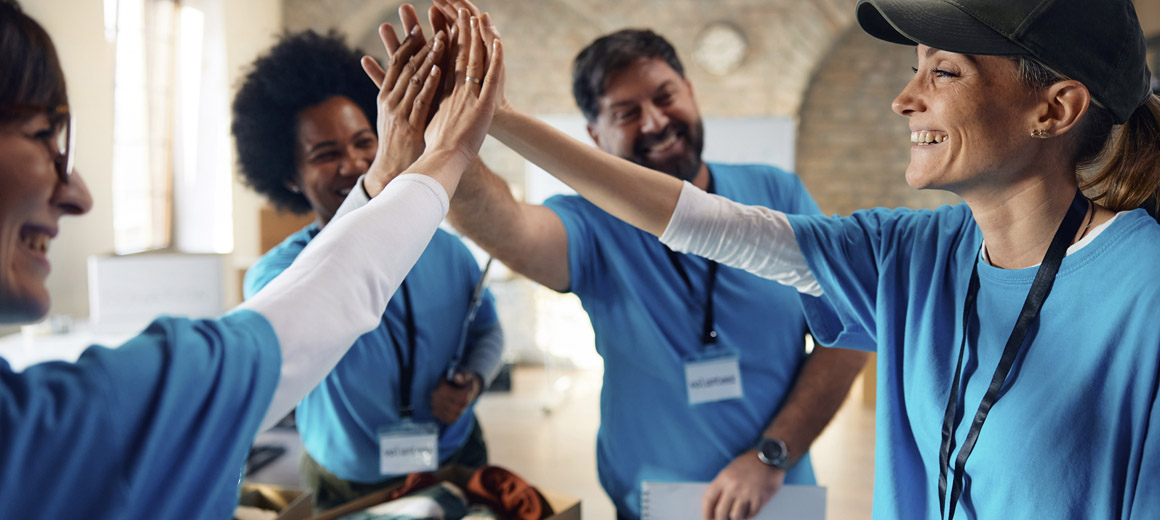 a team wearing matching shirts and high fiving
